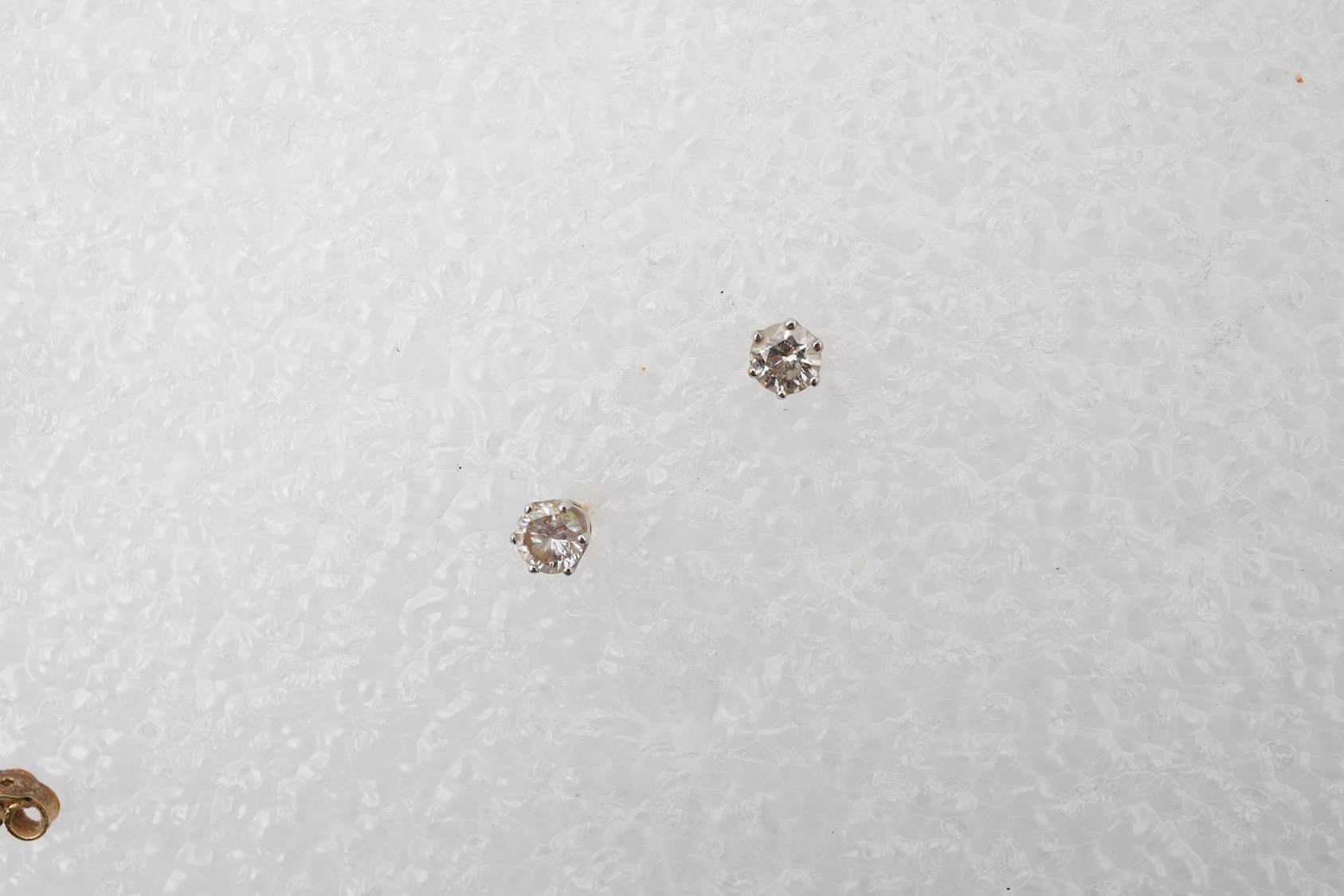 A pair of diamond stud earrings